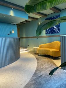 a living room with a yellow couch in a room at Relais sul Mare Boutique Hotel in Naples