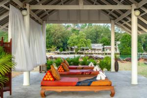 a group of four beds sitting under a pavilion at Koh Chang Longstay Resort in Ko Chang