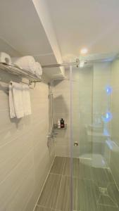 a bathroom with a shower with a glass door at A25 Hotel - 14 Hồ Huấn Nghiệp in Ho Chi Minh City