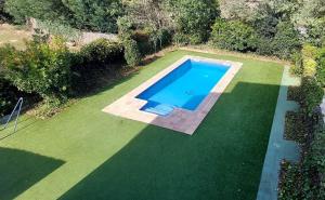 an overhead view of a swimming pool on a lawn at Bravaholidays-601-Lloret Park 1 in Vidreres