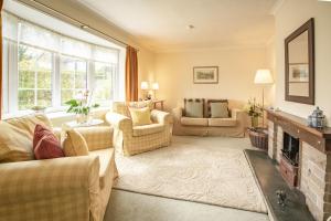 a living room with two couches and a fireplace at Fox Cottage in Middleham