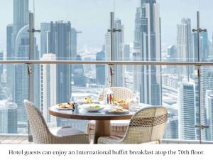 a table on a balcony with a view of a city at SLS Dubai Hotel & Residences in Dubai