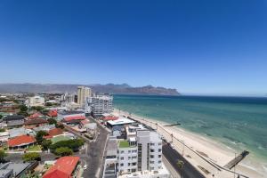 an aerial view of a beach and the ocean at 1402 Hibernian Towers Luxury Self Catering Apartment Strand Western Cape South Africa in Cape Town