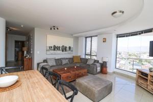 a living room with a couch and a table at 1402 Hibernian Towers Luxury Self Catering Apartment Strand Western Cape South Africa in Cape Town