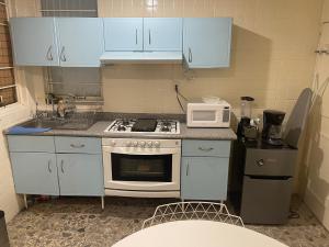 a small kitchen with a stove and a microwave at bnb2night Polanco-Metro in Mexico City