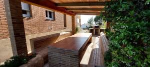 a patio with a bench on the side of a building at Bravaholidays-601-Lloret Park 1 in Vidreres
