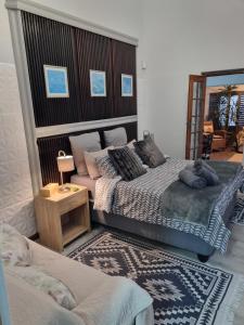 a bedroom with two beds and a mirror at Twelveon1st in Cape Town