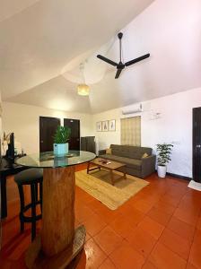 a living room with a table and a couch at BRICK CASTLE in Chennai