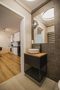 a bathroom with a sink and a large mirror at Apartamenty przy Dworku in Człuchów +44 photos