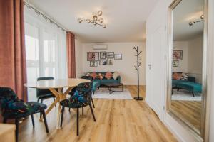 a living room with a table and chairs and a couch at Apartamenty przy Dworku in Człuchów
