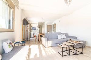 a living room with a couch and a table at Modern Private Villa with Infinity Pool in Heraklion