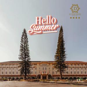 a hotel with a hello summer sign and two trees at Du Parc Hotel Dalat in Da Lat