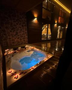 a jacuzzi tub with lights in a room at SEYRİ VADİ suit BUNGALOV in Ardeşen