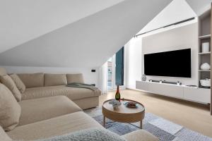 a living room with a couch and a tv at Penthouse Nikolina-50m to beach! - Makarska Exklusiv in Makarska