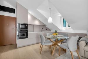 a kitchen and dining room with a table and chairs at Penthouse Nikolina-50m to beach! - Makarska Exklusiv in Makarska