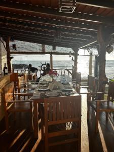 a dining room with a table and chairs and the ocean at White Sand Villa - Beach front in Hikkaduwa