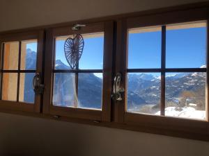a window with a view of the mountains at Chalet Mariabel in Puy-Saint-Pierre