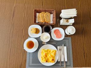a table with plates of food and cups of tea at Guest House Crocus in Bishkek +19 photos