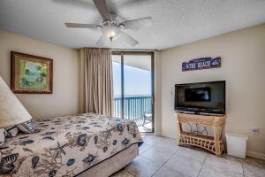 a bedroom with a bed and a flat screen tv at Ocean Bay Club 1201 in Myrtle Beach