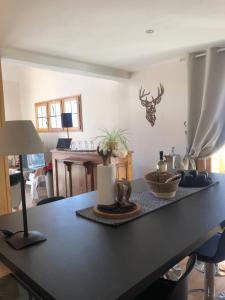 a dining room table with a black counter top at Chalet Mariabel in Puy-Saint-Pierre