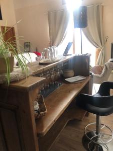 a kitchen with a wooden counter top with a chair at Chalet Mariabel in Puy-Saint-Pierre