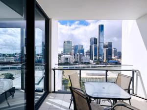 a balcony with a view of a city skyline at Riverview Haven Prime Spot for NY Fireworks in Brisbane