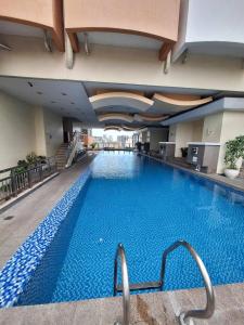ein großer Pool in einem Hotelgebäude in der Unterkunft Birch Tower Studio Condo - Staycation in Manila in Manila