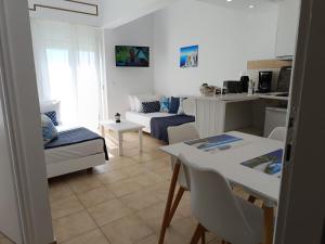 a living room with a couch and a table at Nautilus City Studios & Apartments in Rhodes Town