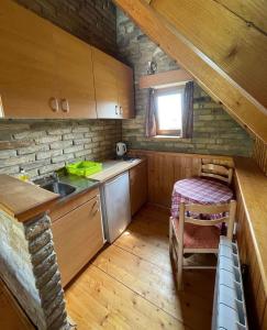 a small kitchen with a sink and a table at Vila Boska Palic in Palić