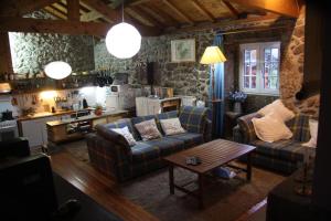 a living room with two couches and a table at Casa do Ribeiro - Casal Pedro in Ponte de Lima
