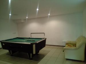 a room with a pool table and a couch at Great place in Rīga