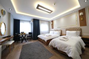 Postel nebo postele na pokoji v ubytování Elita Otel Kumkapı