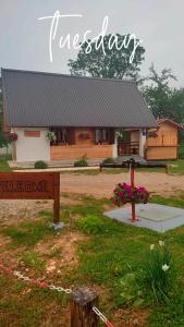 a log cabin with a sign in front of it at Kuća za odmor Antonija in Gospić