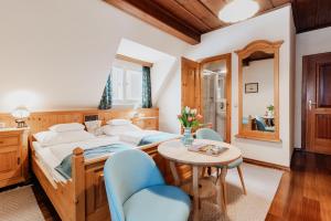 a bedroom with a bed and a table and chairs at Landhaus Koller in Gosau +69 photos