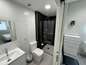 een badkamer met een toilet, een wastafel en een douche bij Garden City Lofts in Córdoba