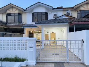 a white fence in front of a house at 8min Port Dickson beach 17pax Pet Friendly in Port Dickson