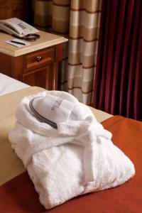 a white towel sitting on top of a bed at Hotel Mascagni in Rome