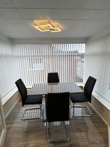 a conference room with a table and chairs at 230 Councillor Lane in Cheadle