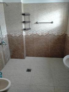 a bathroom with a shower with a toilet and a sink at Peridot Vacation Inn, Bahria in Mingora
