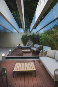a patio with couches and tables on a wooden deck at Eilenriedestift Appartements in Hannover