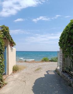 a road leading to a beach with the ocean at Niki Seaside Apartments in Platamonas