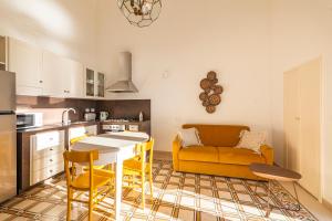 a kitchen and living room with a table and a couch at Casa Mea in Nardò