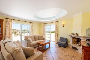 a living room with a couch and a fireplace at Villa Vista Marina in Albufeira