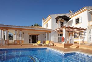 a villa with a swimming pool and a house at Villa Jumar in Albufeira