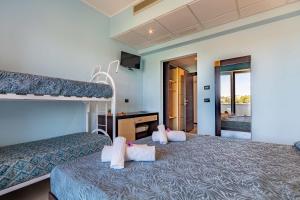 Postel nebo postele na pokoji v ubytování Jonico Hotel
