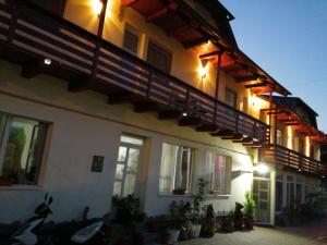 a building with a balcony with plants on it at casa Dany&Ady in Râşnov
