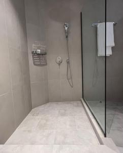 a shower with a glass door in a bathroom at Halima Shared Housing - Female only in Dubai