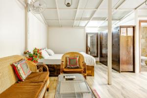 a living room with a bed and a couch at Cp Villa - Rooms with Patio in New Delhi