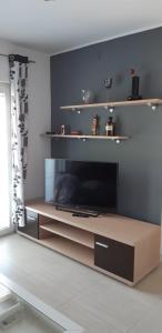 a living room with a large flat screen tv at Apartments Perina in Tisno
