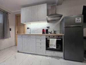 a kitchen with a stainless steel refrigerator and freezer at Margaret House in Zakynthos